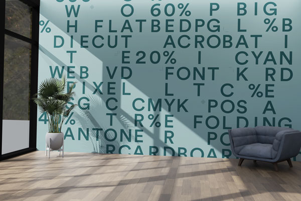 Open living area with a teal wall covered in scattered dark letters, a potted plant, and a blue-gray chair on a wood floor.